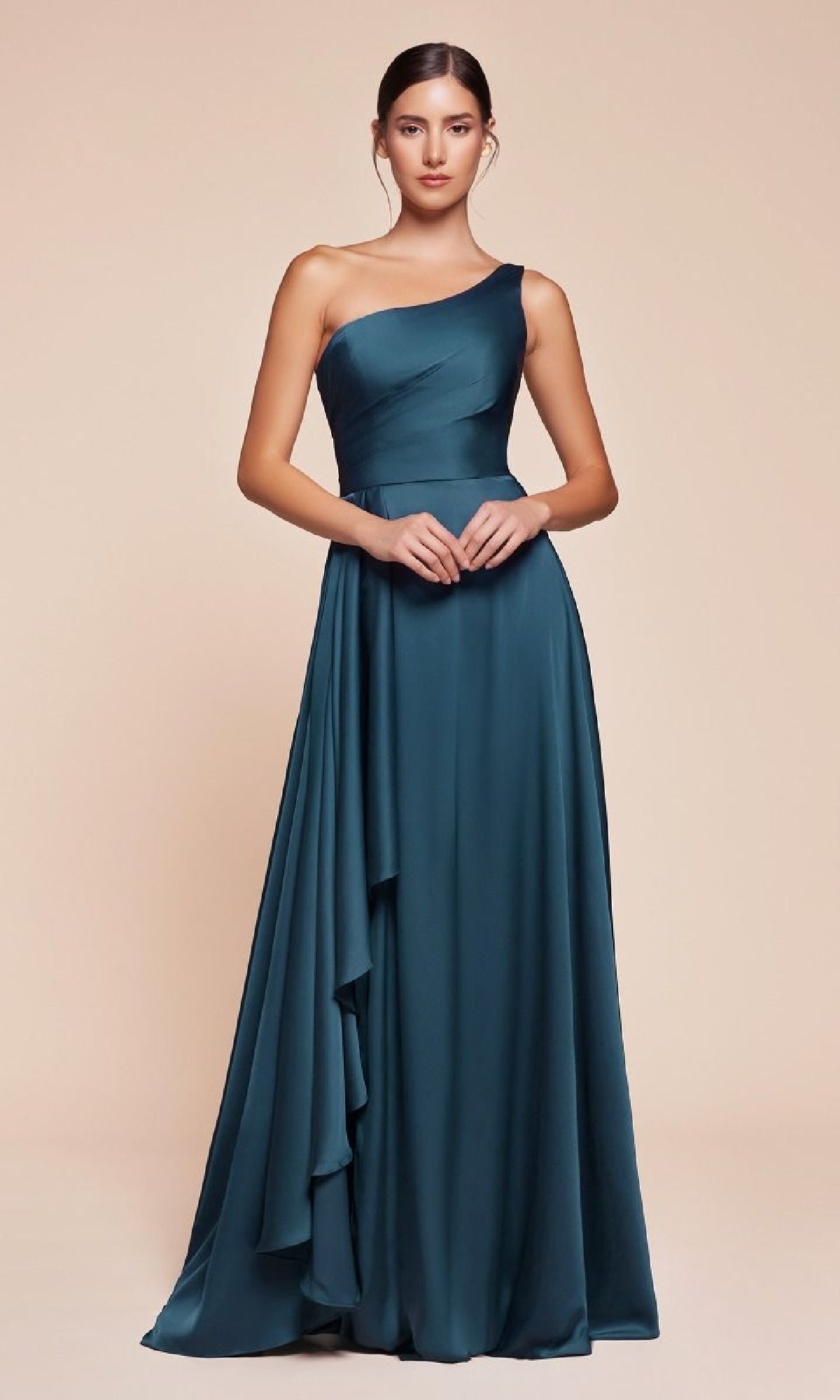 A woman models the Ladivine 7450, a teal one-shoulder long A-line prom dress with a fitted bodice and draped skirt, ideal as an affordable formal gown, set against a plain beige background.